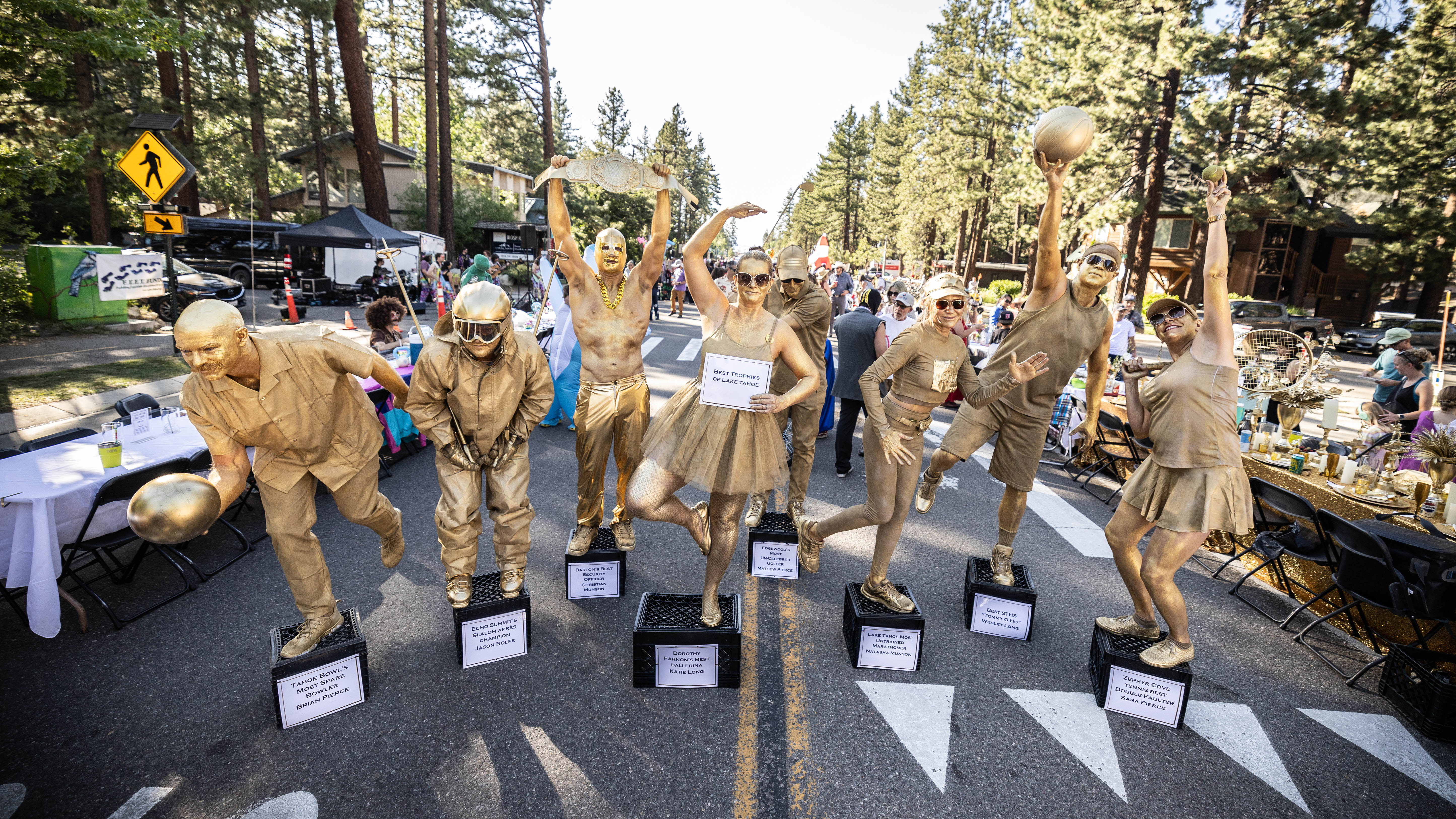 2025 Best Table Contest winners painted in gold body paint posing as living trophies